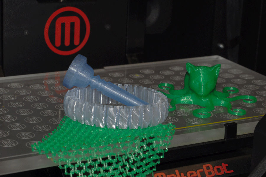 Computer science students explored 3D printing technology by creating objects with the MakerBot Replicator II, such as an octo-cat and flexible chain mail printed as separate but linked loops.