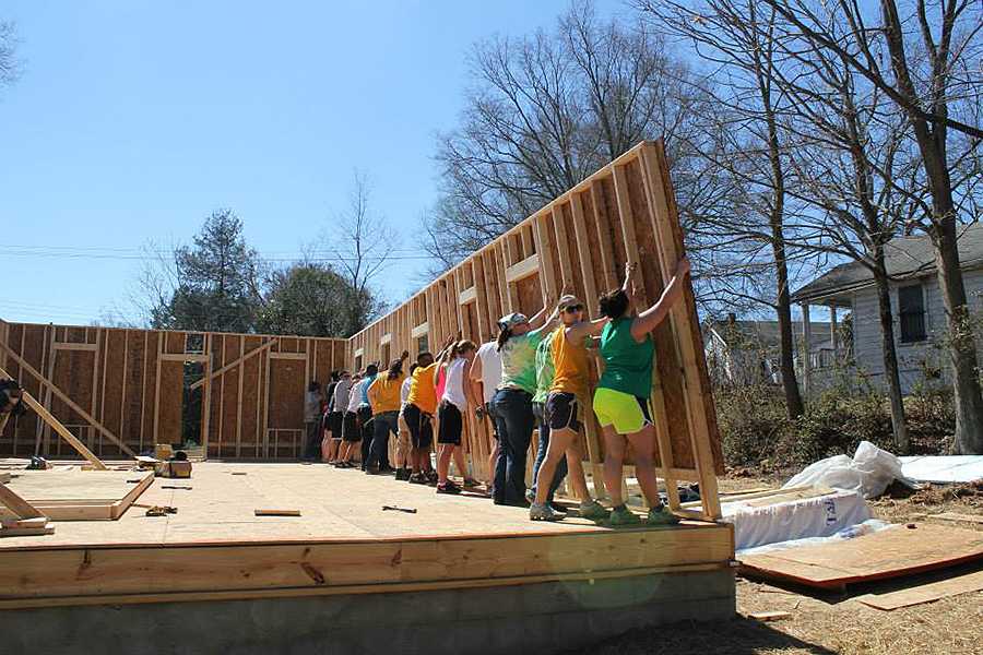 Habitat for Humanity volunteers joined forces to raise and support a wall while it was installed.