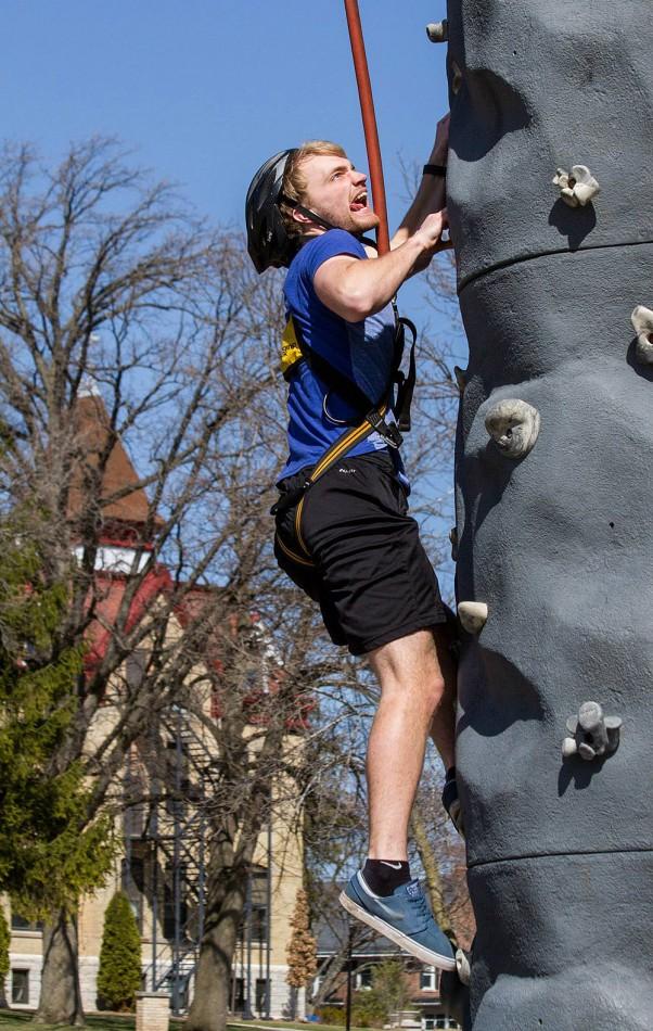 Student Josh Mann scales the rock climb.