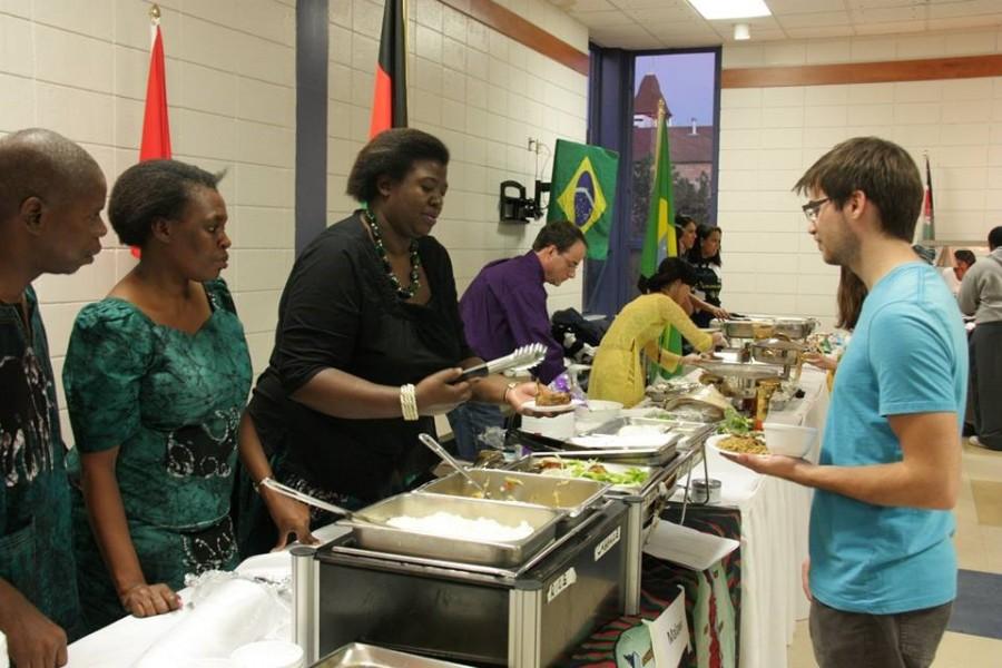 Students receive food from booths at last years International Food Night. This year the annual event will take place Saturday, Oct. 24.