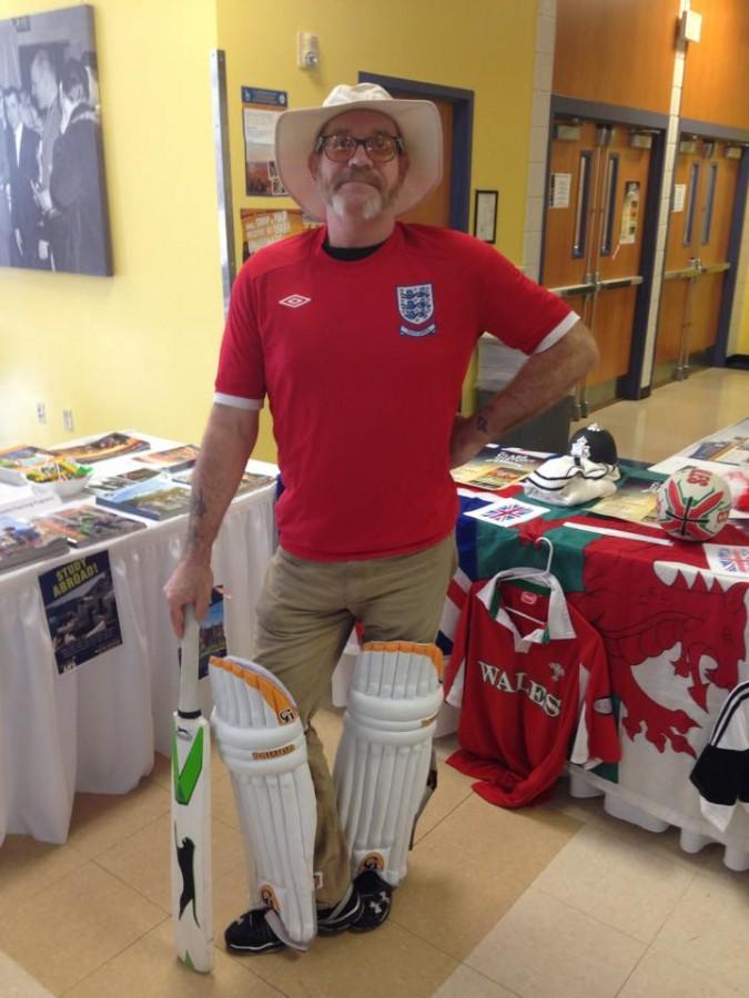  Rick Dodgson, Associate Professor of History, stands with cricket bat at the Study Abroad table in Bossard to help promote International Education Week.