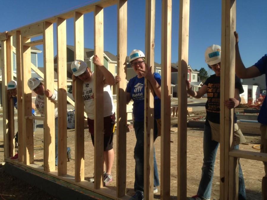After a week of work, students raise the first wall at the work site.