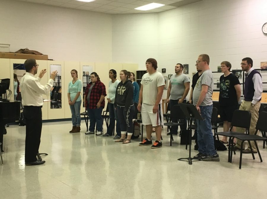 John Guarente, new assistant professor of music and director of choral activities, directs his choir. 
