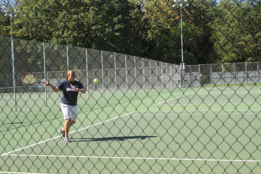 Mikayla Hilton, senior sports management major, uses an aggressive forehand to win the point.