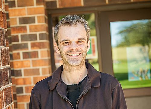 A smiling Chris Werner stands outside of Verhulst.