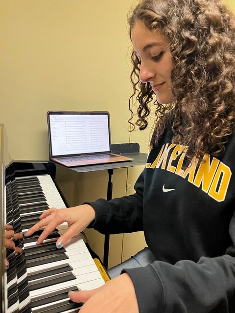 Ashley Esser practicing her compositions on the piano. Photo Credit: Ashley Esser 