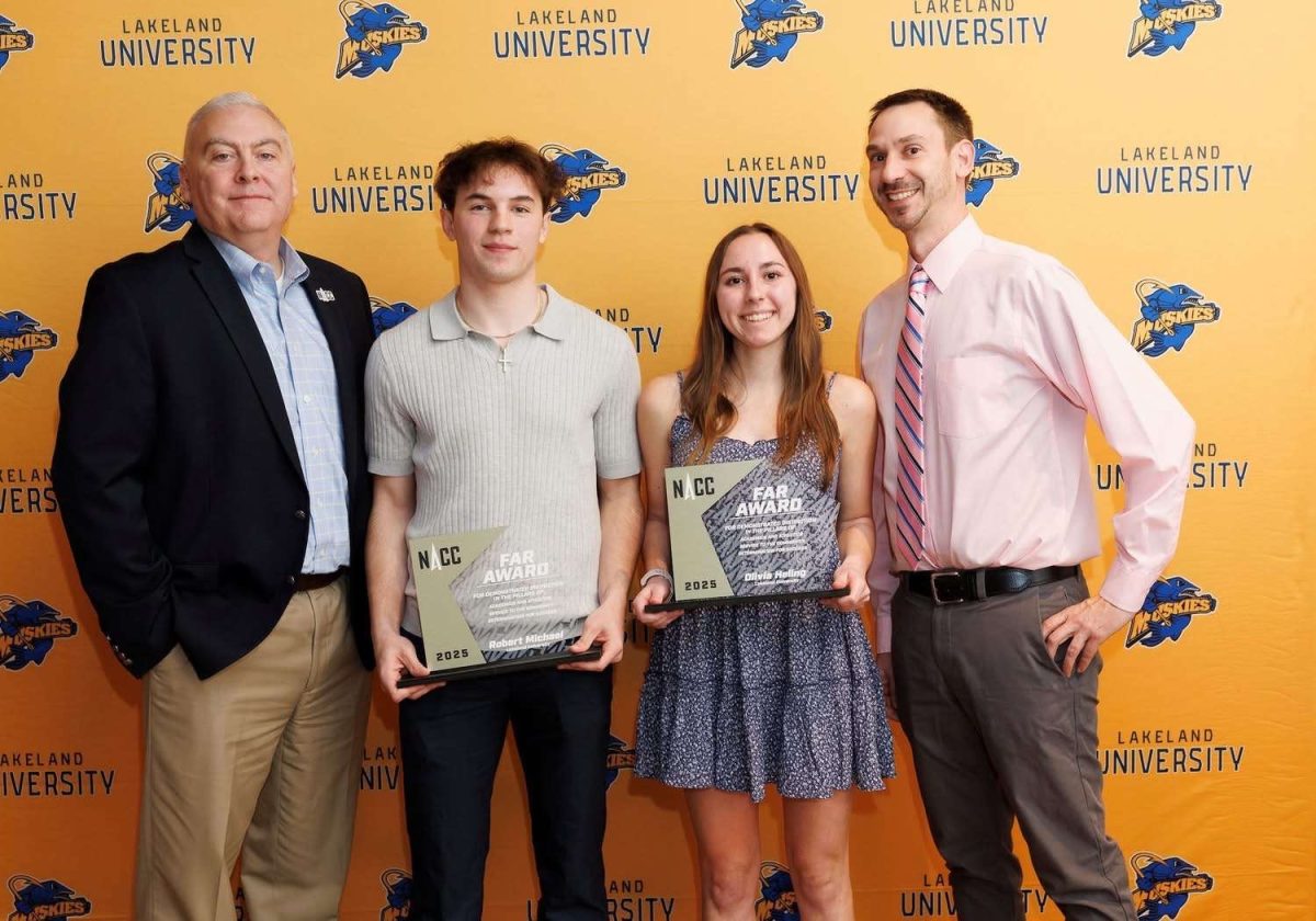 Robby Michael and Olivia Heling proudly receive the NACC Faculty Athletics Representative Award. 