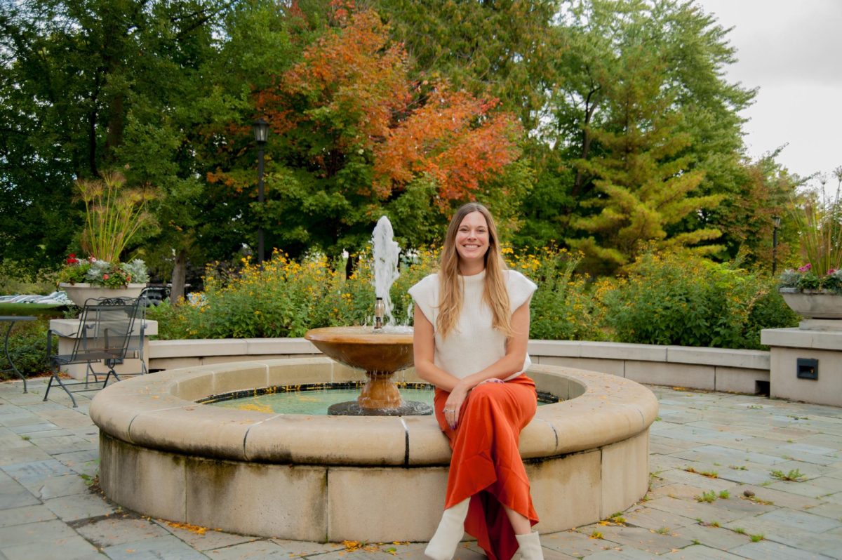 Counselor Staci Haley enjoys the peaceful atmosphere by Old Main’s fountain.