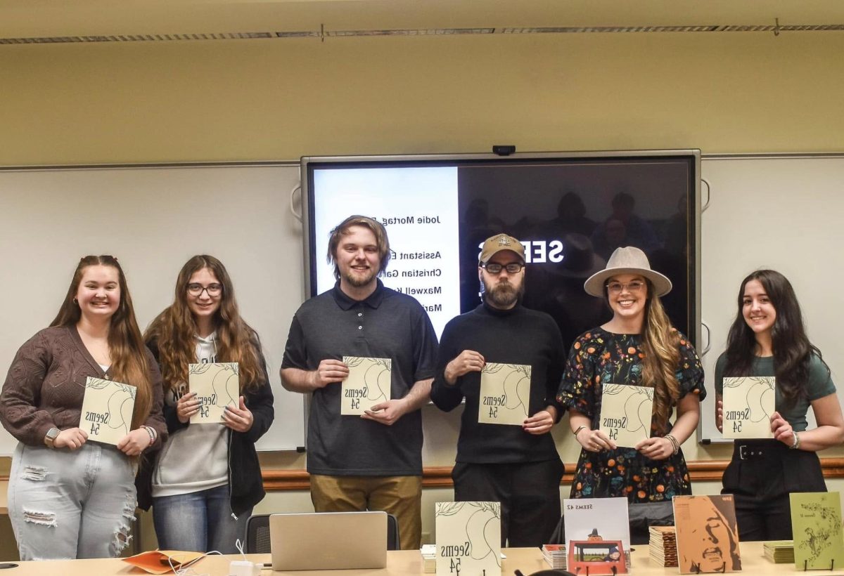 Caption: Left to right: Kaytlyn Weidig, Leah Henckel, Maxwell Kutz, Christian Gartner, Jodie Mortag and Marian Cramer present Seems 54 at the 2023 Lakeland Undergraduate Research Symposium. Photo taken in April 2023. 